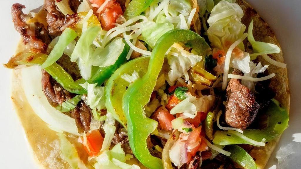Steak Fajita · Marinated and grilled flank steak served with bell peppers and onions. Topped with pico, lettuce, and shredded jack cheese