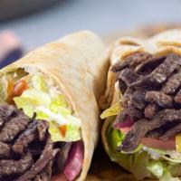Beef Shawarma Wrap · Beef Shawarma in a wrap with: lettuce, tomatoes, tabooleh, pickles, onions, and hummus toppe...