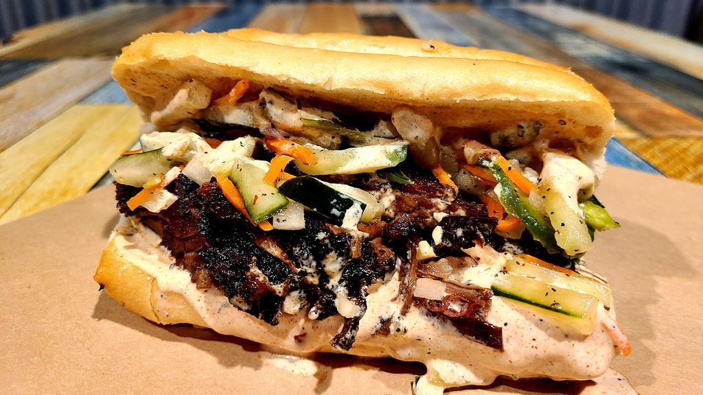 The 1834 · Beef brisket on a French roll topped with homemade giardiniera, spicy mayo and a side of au jus.
