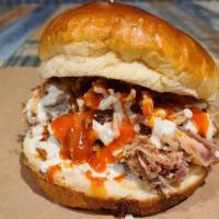 Buffalo Chicken Ranch Sandwich & 2 Sides · Pulled chicken topped with house made buffalo sauce and creamy ranch dressing.