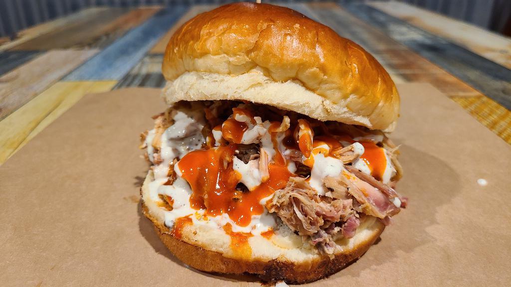 Buffalo Chicken Ranch Sandwich & 2 Sides · Pulled chicken topped with house made buffalo sauce and creamy ranch dressing.