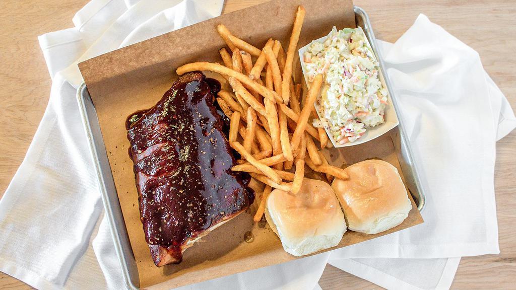 ½ Rack Of Ribs, 2 Sides & 2 Garlic Butter Rolls · Half rack of smoked baby back ribs with 2 single side items and 2 rolls.