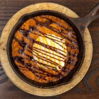 Cast Iron Chocolate Chip Cookie · With vanilla ice cream, caramel, and fudge sauce.