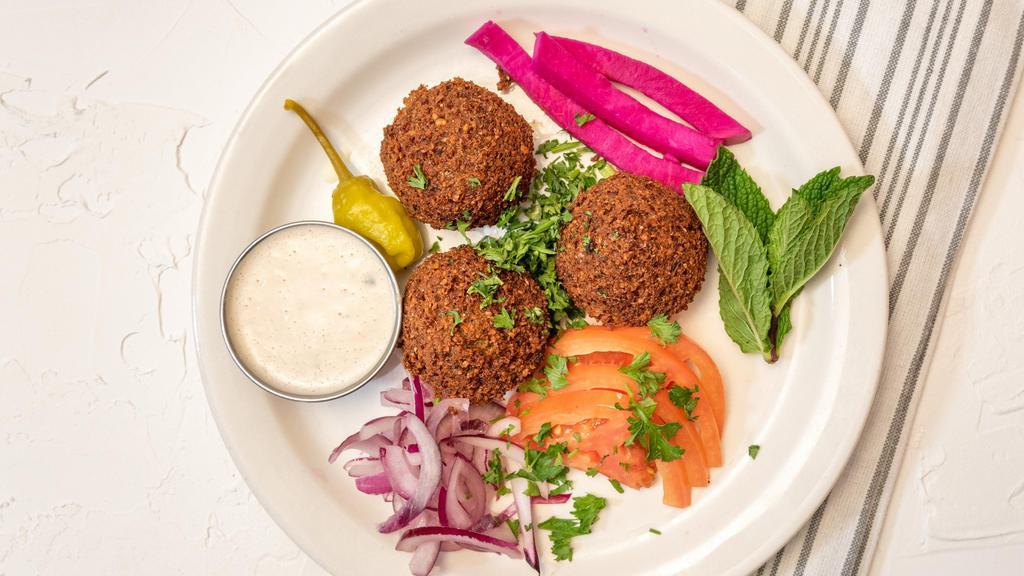 Falafel Appetizers · Vegetarian. Deep fried vegetable patties made of chick peas, fava beans, garlic, cumin, and coriander. Served with  tomatoes, pickled turnips, tahini sauce, and pita bread.