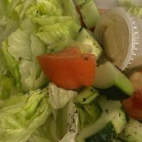 Greek Salad · Lettuce, tomatoes, cucumbers topped with onions, olives, feta cheese, pepperoncini, and Gree...