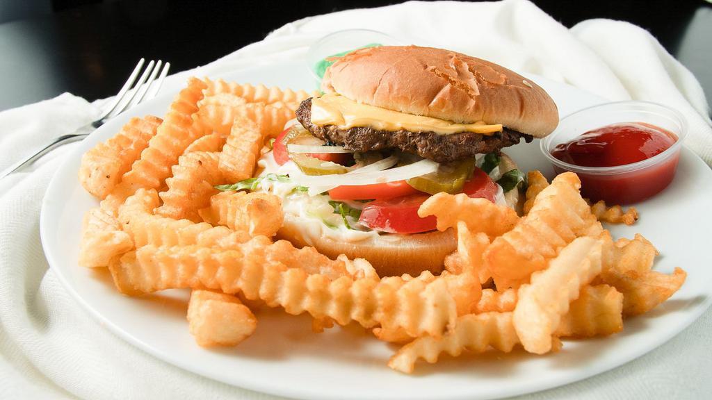 Lebanese Burger · Our 100% chuck beef burger served on a bun with tomato, pickles, ketchup, onion, coleslaw salad and mayo.