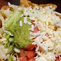 Taco Salad · Our classic salad of lettuce in a flour tortilla shell with tomatoes, cheese, sour cream, gu...