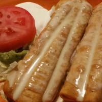 Texas Chimichanga · Steak, chicken and shrimp grilled with onions, peppers and tomatoes, topped with cheese. Ser...