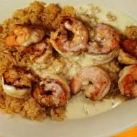 Camarones Al Mojo De Ajo · Juicy shrimp laced with garlic and served with rice, beans, lettuce, avocado slices and onio...
