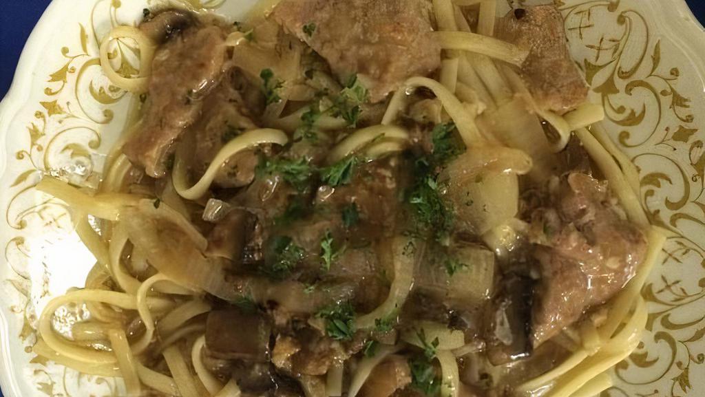 Chicken Marsala · Sauteed chicken breast with mushrooms and onions in a marsala wine sauce. Served over linguine with salad and rolls.