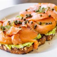 Smoked Salmon Avocado Toast · Two slices of multi-grain toast slathered with cream cheese, avocado and topped with thinly ...