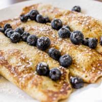 Fruit Crêpes · Three crêpes filled and topped with your choice of strawberries, blueberries, or bananas.