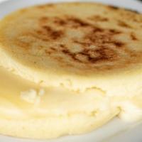 Arepa Con Queso · Colombian style white cornbread with melted cheese.