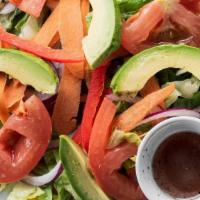Ensalada · House salad made with romaine lettuce, tomatoes, onions, and carrots.