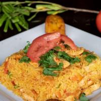 Arroz Con Pollo · Yellow rice mixed with chicken and vegetables and served with sweet plantains.