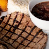 Carne Asada · Grilled steak served with rice, beans, sweet plantains, and salad.