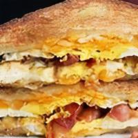 Fried Egg Grilled Cheese · 2 fried eggs, bacon, cheese (choice), tomato on choice of bread
