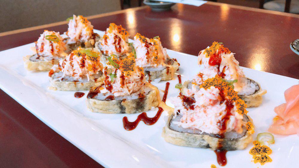 Yummy Roll · Tuna, salmon, yellowtail, crab and cream cheese inside and light tempura topped with Alaskan crab meat and masago.