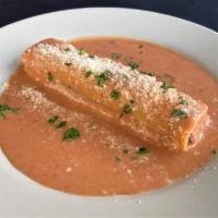 Baked Cannelloni · Tubular pasta filled with beef, chicken, veal and spinach, served in tomato cream sauce