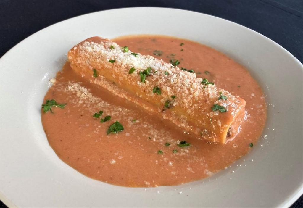Baked Cannelloni · Tubular pasta filled with beef, chicken, veal and spinach, served in tomato cream sauce