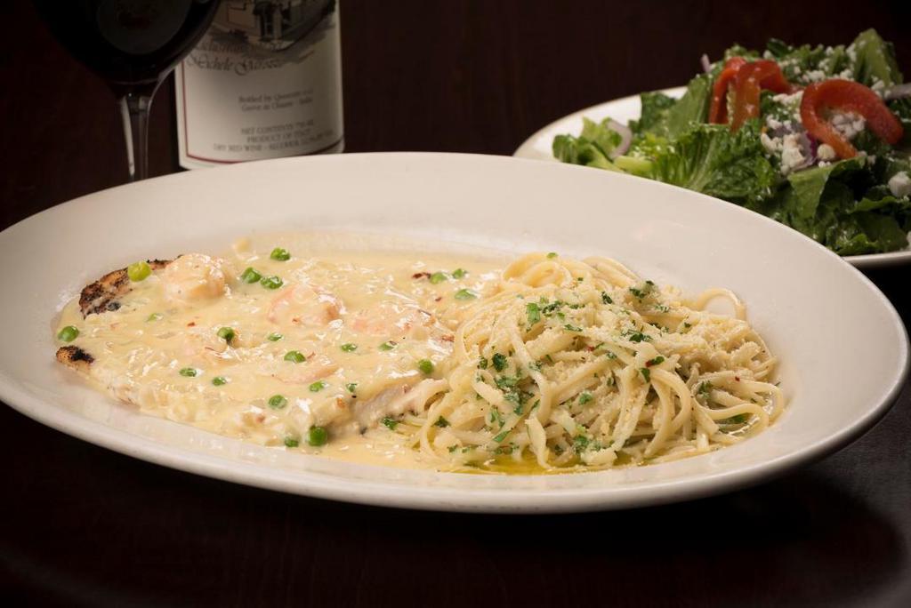 Frankie'S Chicken · Lightly breaded, grilled & topped with provolone cheese, sauteed shrimp and a white wine dijon cream sauce with onions and peas.  Served with linguine in olive oil and garlic