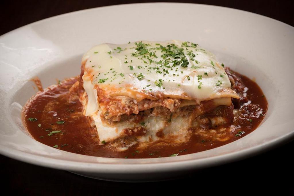 Baked Lasagna · Layered with Italian sausage, beef, ricotta cheese and Maggie's sugo, topped with provolone cheese