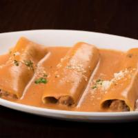Cannelloni · Tubular pasta filled with beef, chicken, veal and spinach, served in tomato cream sauce