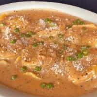 Seafood Ravioli Mario · Filled with shrimp, scallops and lobster in a sherry wine sauce with roasted tomatoes, peas ...
