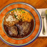 Pollo Con Mole · Chicken leg and thigh cooked to perfection in our homemade mole sauce, served with Mexican r...