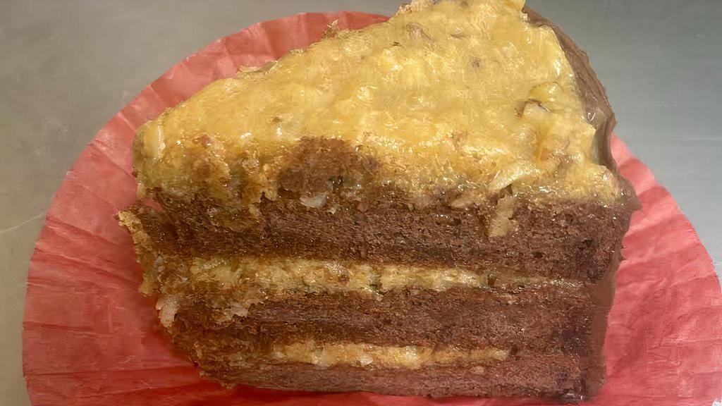 German Chocolate Cake · Three layers of chocolate cake filled with icing of caramel, coconut, and pecans and sided with chocolate smooth icing.