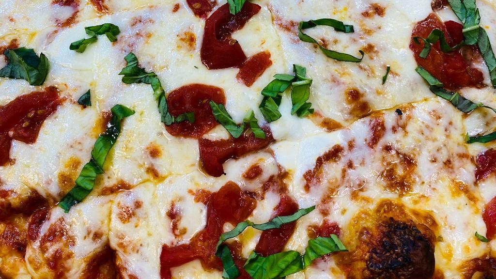 Large Margherita Pizza  · Big Kel's Marinara, Fresh Basil, Tomatoes, Fresh Mozzarella Cheese and Pizza Cheese

+Try it with Roasted Pulled Chicken