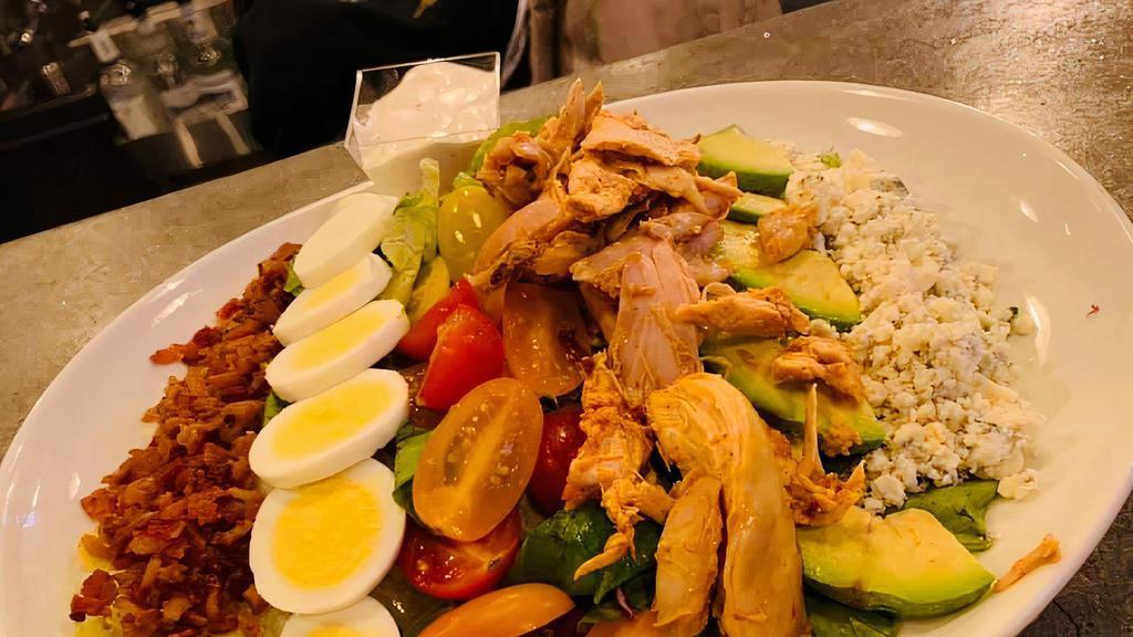 Cobb Salad · Tomato, Bacon, Hard Boiled Egg, Bleu Cheese Crumbles, Avocado and Big Kel's Roasted Pulled Chicken and Lettuce Mix  served with Creamy Bleu Cheese Dressing. Served with a slice of  Homemade Bread.