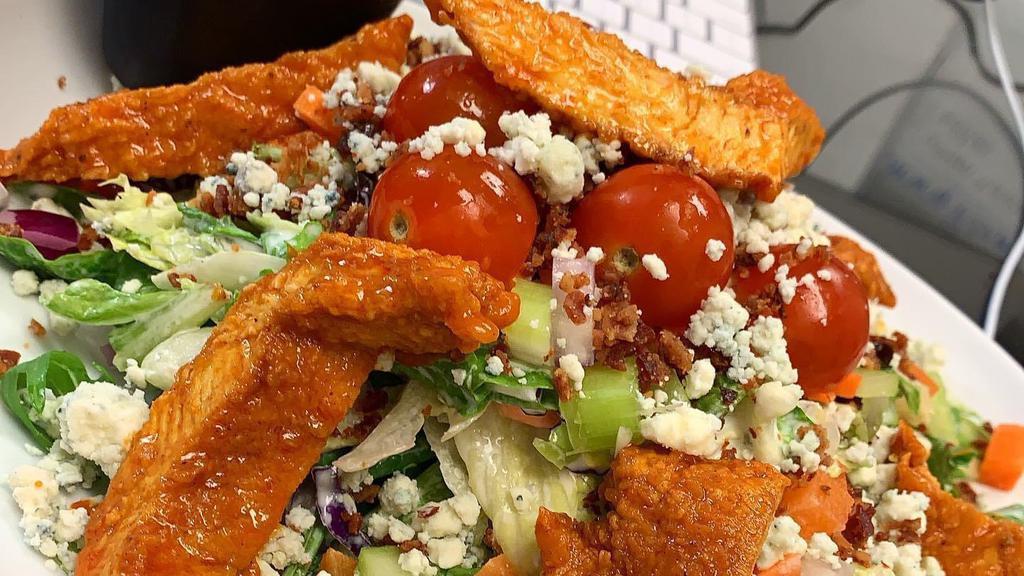 Crispy Buffalo Chicken Salad · Lettuce mix, Red Onions, Bacon, Celery, Carrots, Bleu Cheese Crumbles, Tomato tossed in Creamy ranch. Topped with Crispy Buffalo Chicken. Served with a slice of Homemade Bread.
 + Grilled chicken also available
