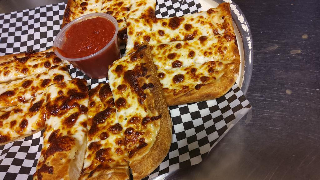 Cheese Bread · Pizza crust with garlic butter seasoning and mozzarella cheese served with a side of marinara sauce.