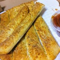 Breadsticks · Pizza crust with garlic butter and parmesan seasoning, served with a side of marinara sauce.