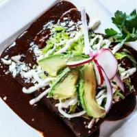Enchiladas De Mole Poblano · 3 Enchiladas filled with Meat or Cheese topped with Mole Sauce, Cheese, Sour Cream and Avoca...