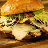 Growler · Smoked turkey, aged cheddar, pig candy, avocado mayo, lettuce and onion.