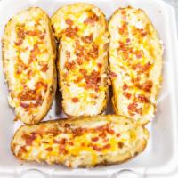 Potato Skins · Potato skins is four skins, loaded with three cheeses, bacon, and sour cream on the side.