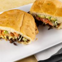 Asada Torta · Steak. Served with refried beans, lettuce, tomatoes, cheese and mayonnaise.