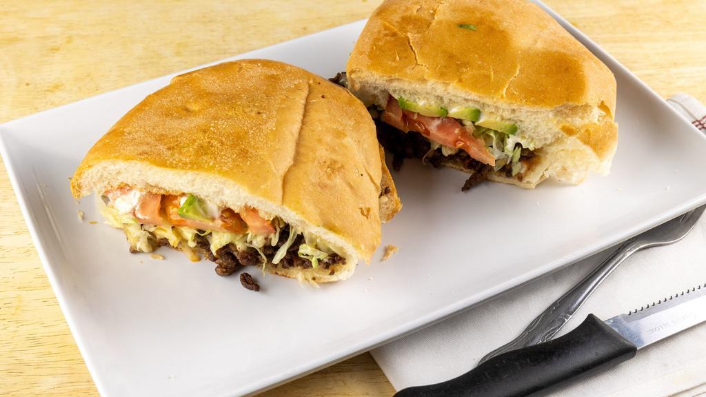 Asada Torta · Steak. Served with refried beans, lettuce, tomatoes, cheese and mayonnaise.