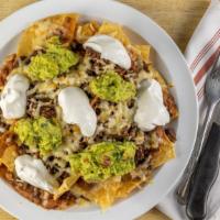 Nachos With Meat · Chips with choice of meat, melted cheese, beans, guacamole and sour cream.