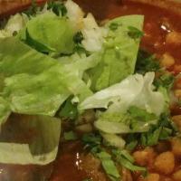 Pozole · Homemade pork broth, shredded pork, served with lettuce, cilantro, onion y chips on the side.