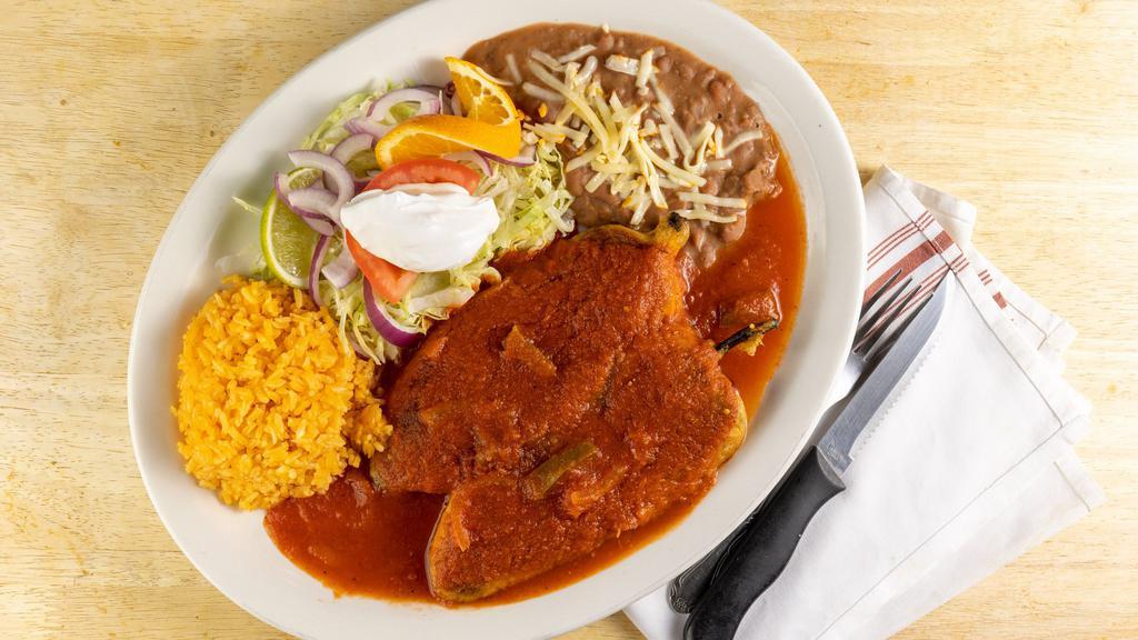 Chile Relleno Dinner · Two poblano peppers stuffed with cheese topped with special red sauce and sour cream. Served with rice, beans, salad and tortillas.