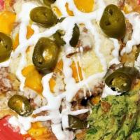 Nacho Supreme · A platter full of home made chips, served with beans, cheese, guacamole and sour cream.