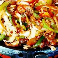 Shrimp Fajitas De Camaron · Jumbo butterfly shrimp grilled with peppers, onion and tomatoes, served with rice beans and ...