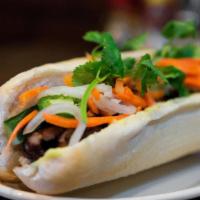 Banh Mi Thit Heo (Grill Pork) · Baguette with grilled pork and pickled carrots/daikon, cilantro, jalapenos & mayo.