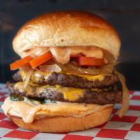 The Rough Rider · Double smash patty with cheddar cheese, layered with Tangy BBQ, Onion rings, and Applewood s...