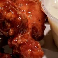 Buffalo Wings · A full pound of marinated, spicy jumbo wings, ranch and bleu cheese dressings for dipping.