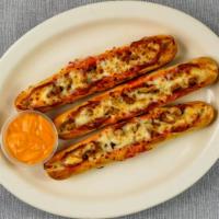 Stuffed Breadsticks · Breadsticks stuffed with sausage and pepperoni served with nacho cheese sauce.