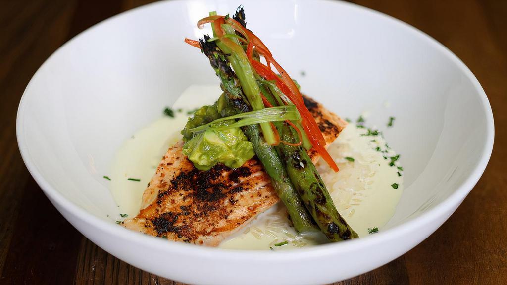 Blackened Salmon · Wild caught blackened salmon with lemon cream sauce, served over steamed rice with avocado salsa, and grilled asparagus